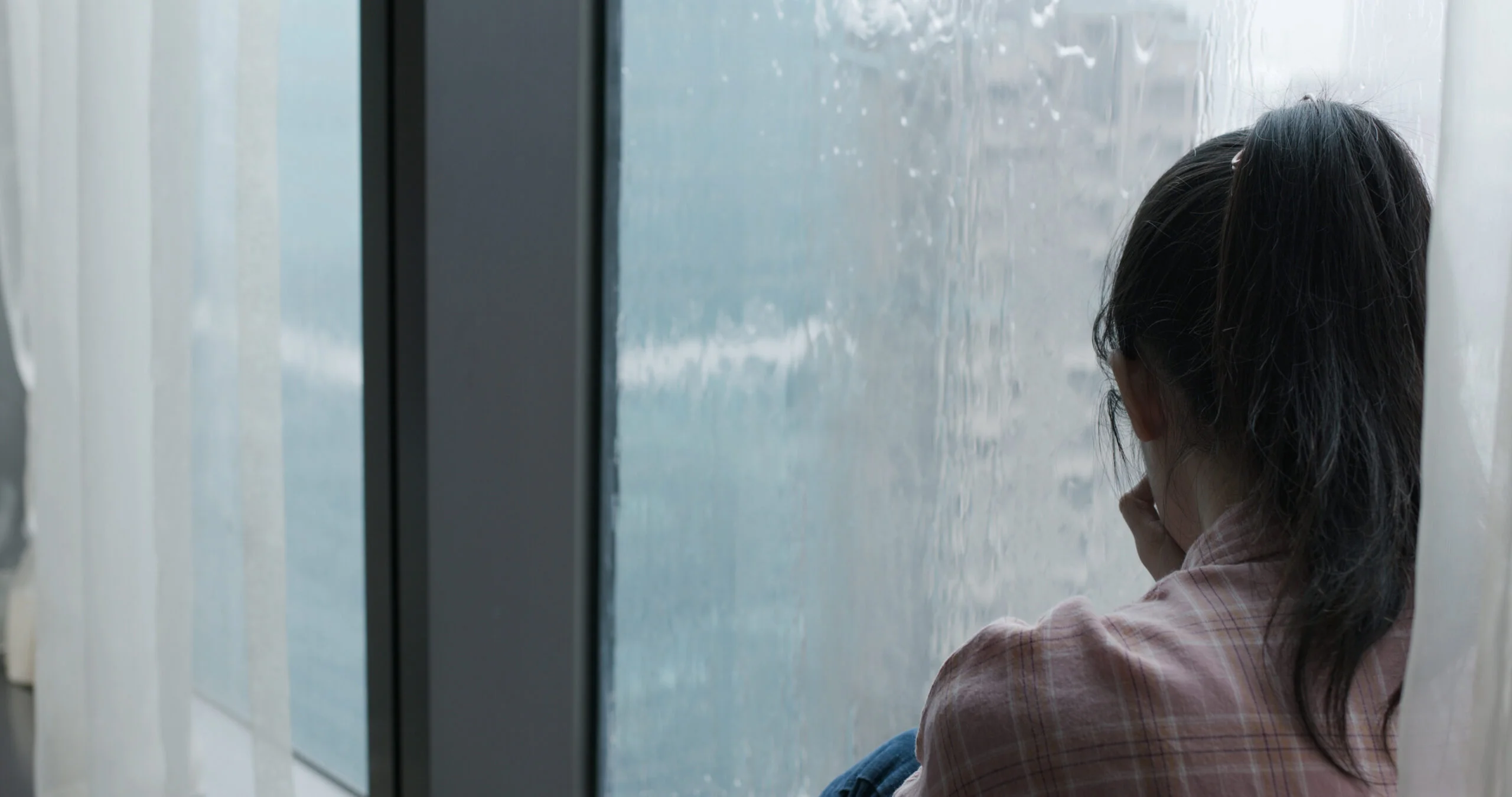 woman cry near window