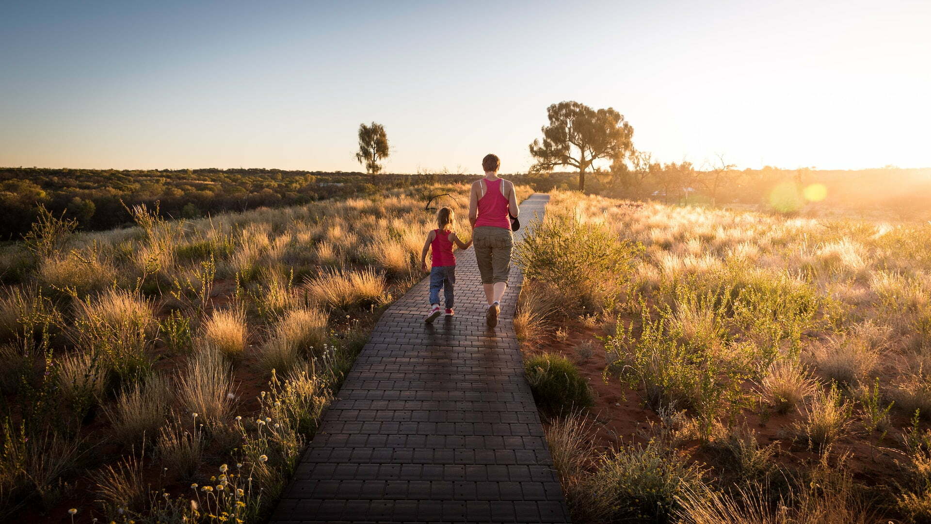 mother, child, holding hands, walking through field