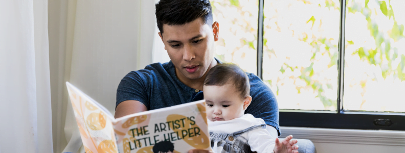 Dad reading to baby