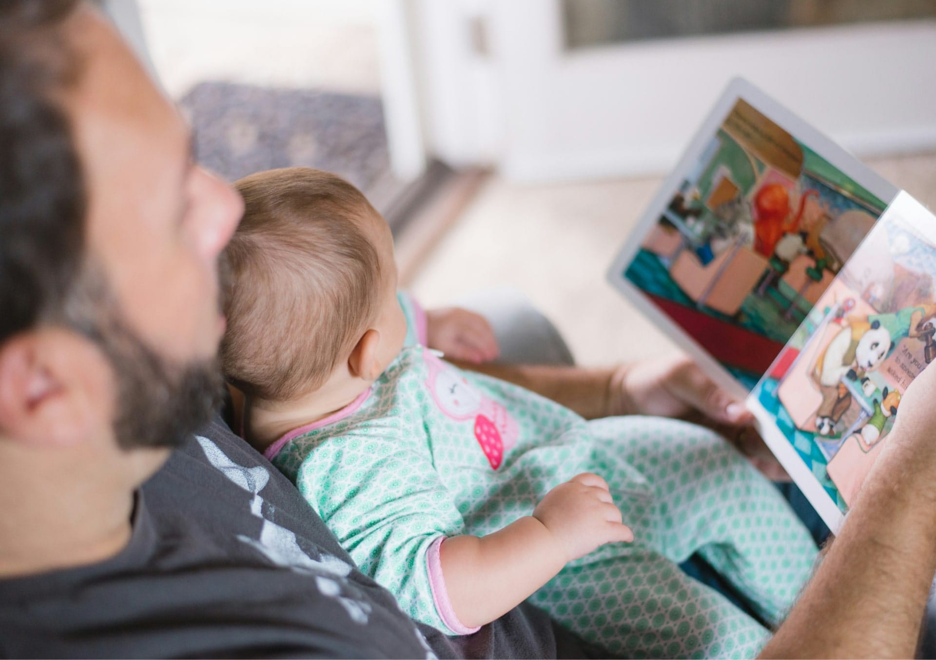 storytime, father reading a picture book to baby